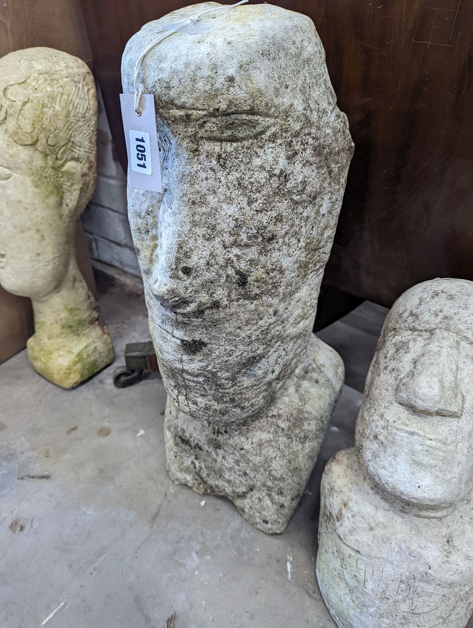 Three reconstituted stone Easter Island style garden ornaments, largest height 58cm